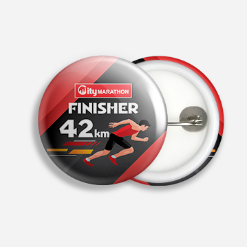 A button badge with an image of a man sprinting, and labelled “Finisher - 42km”.